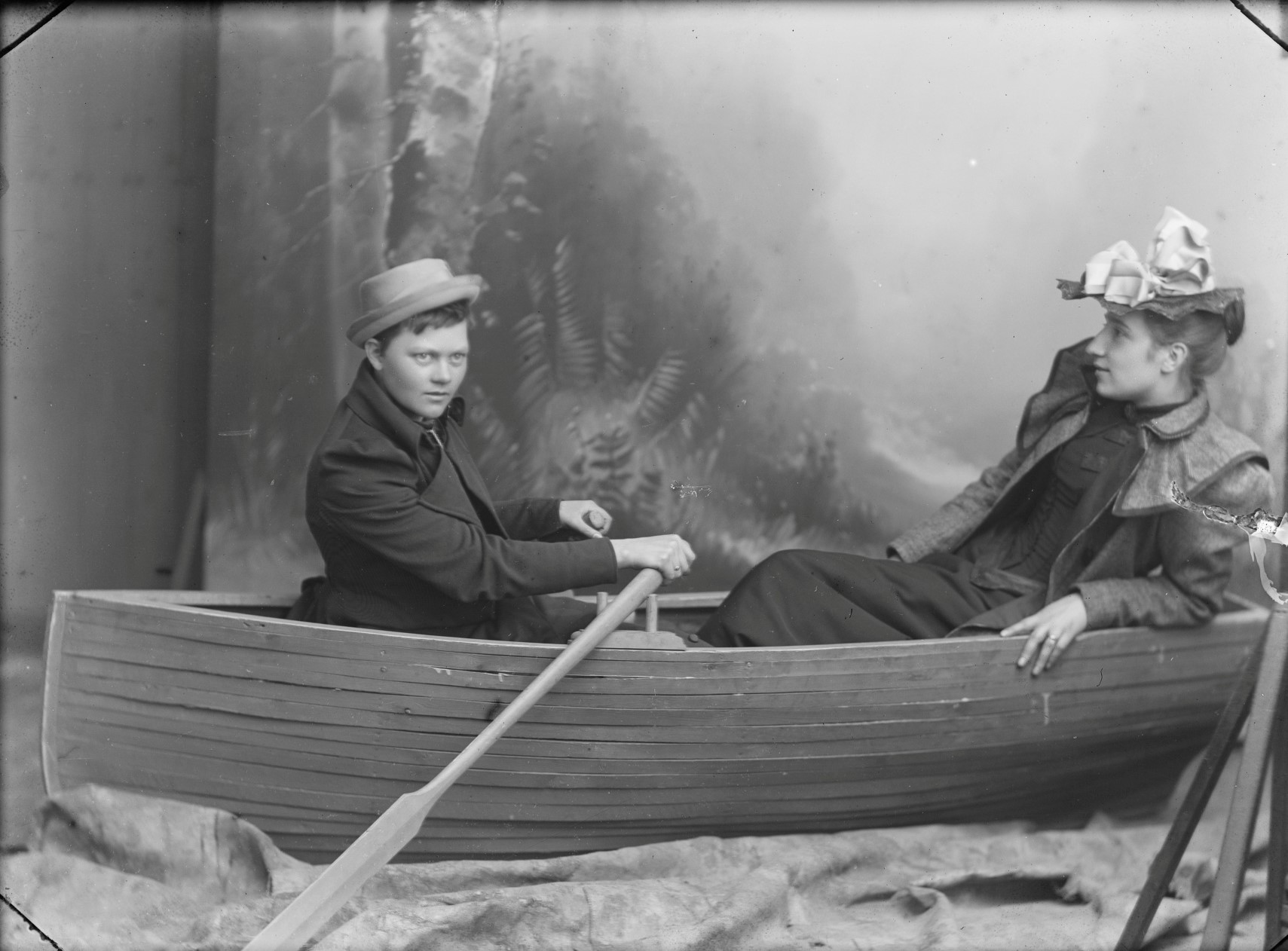 Berg & Høeg, Marie Høeg and Bolette Berg in boat in studio, 1895—1903. Preus Museum collection