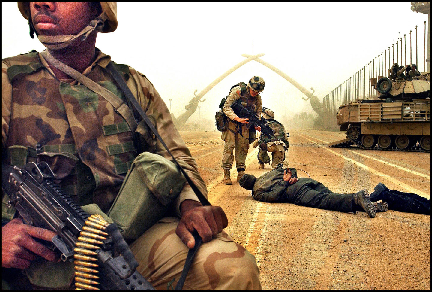 © Harald Henden / VG, Baghdad city center, April 2003. Preus Mueum collection. Copyright Henden / VG. US troops have stormed the rally in Baghdad, where Saddam Hussein was holding all his military parades. The swords in the background are the victory monuments after the Iran / Iraq war.  